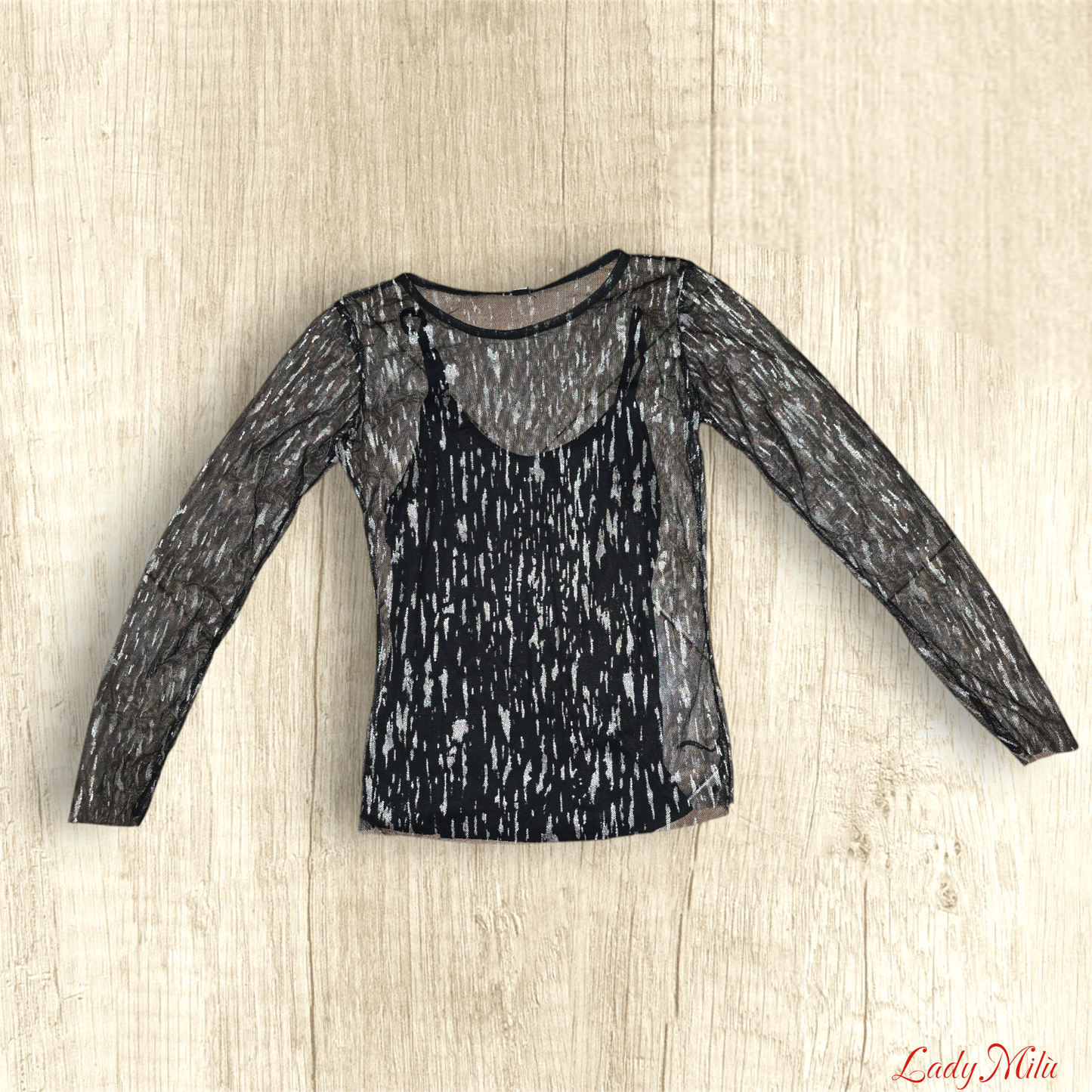Maglia trasparente nera e e oro con canotta nera